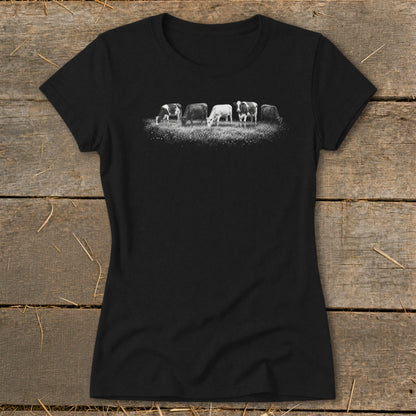 Black t-shirt with a black and white graphic of five cows grazing in a field.