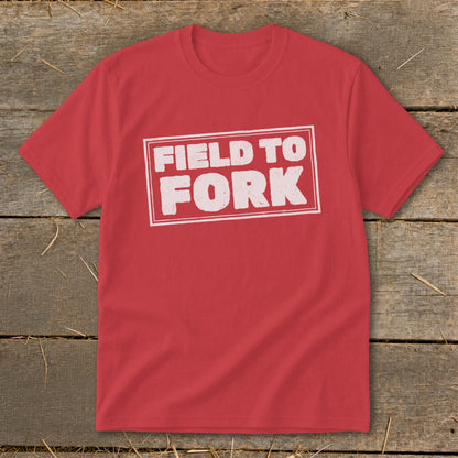 A red short-sleeved t-shirt with a distressed white box graphic that reads Field to Fork.