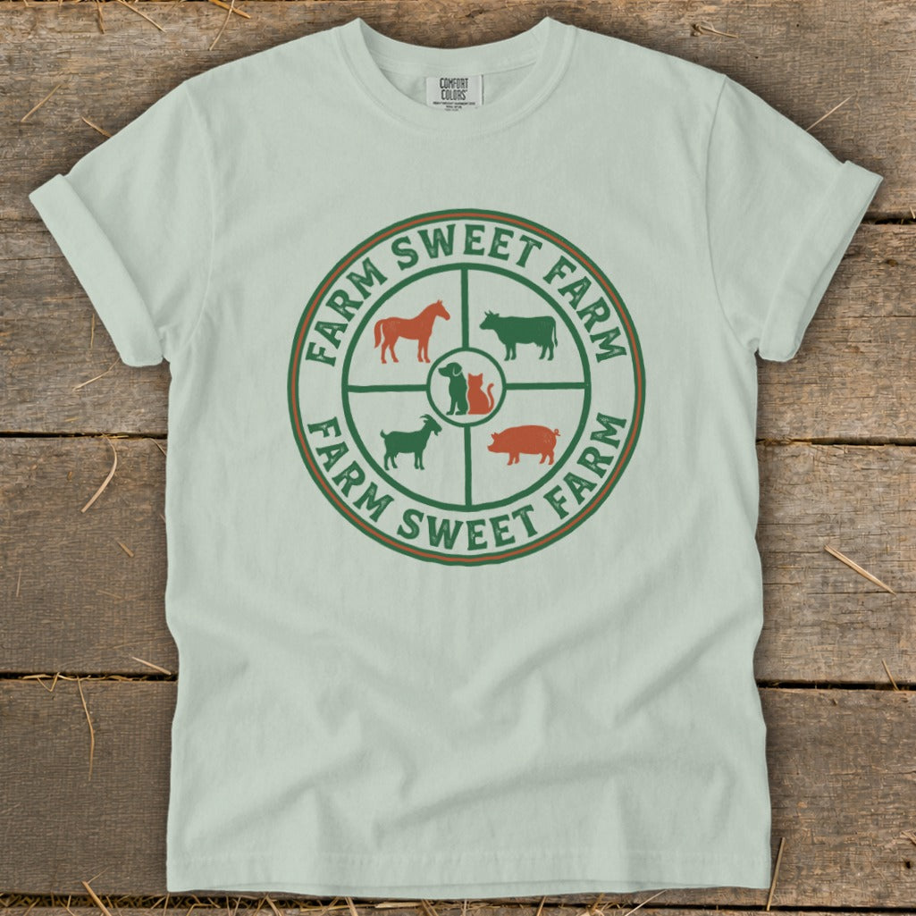 Light green t-shirt with a circular farm animal logo and "Farm Sweet Farm" text.