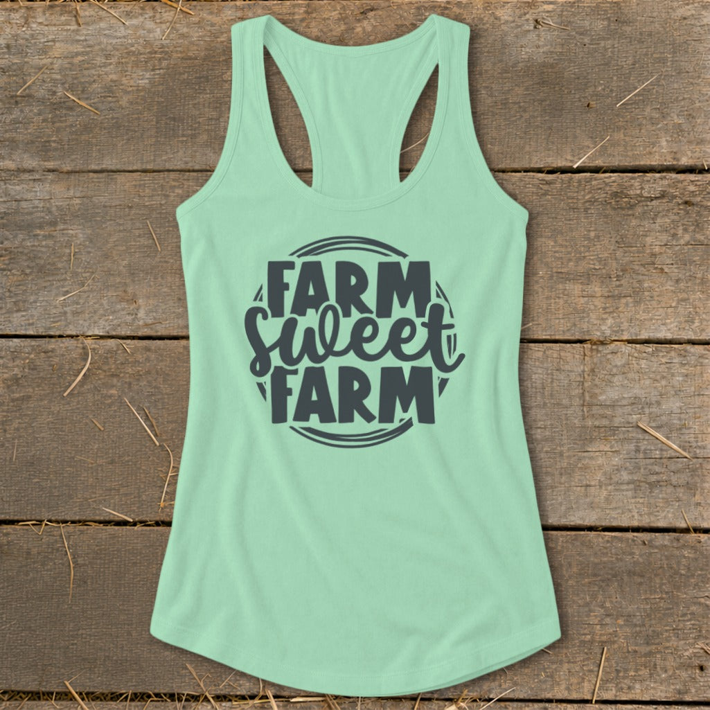 Mint green racerback tank top with "Farm Sweet Farm" text graphic.