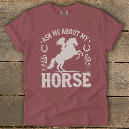 T-shirt with silhouette of woman riding horse, text "ASK ME ABOUT MY HORSE".
