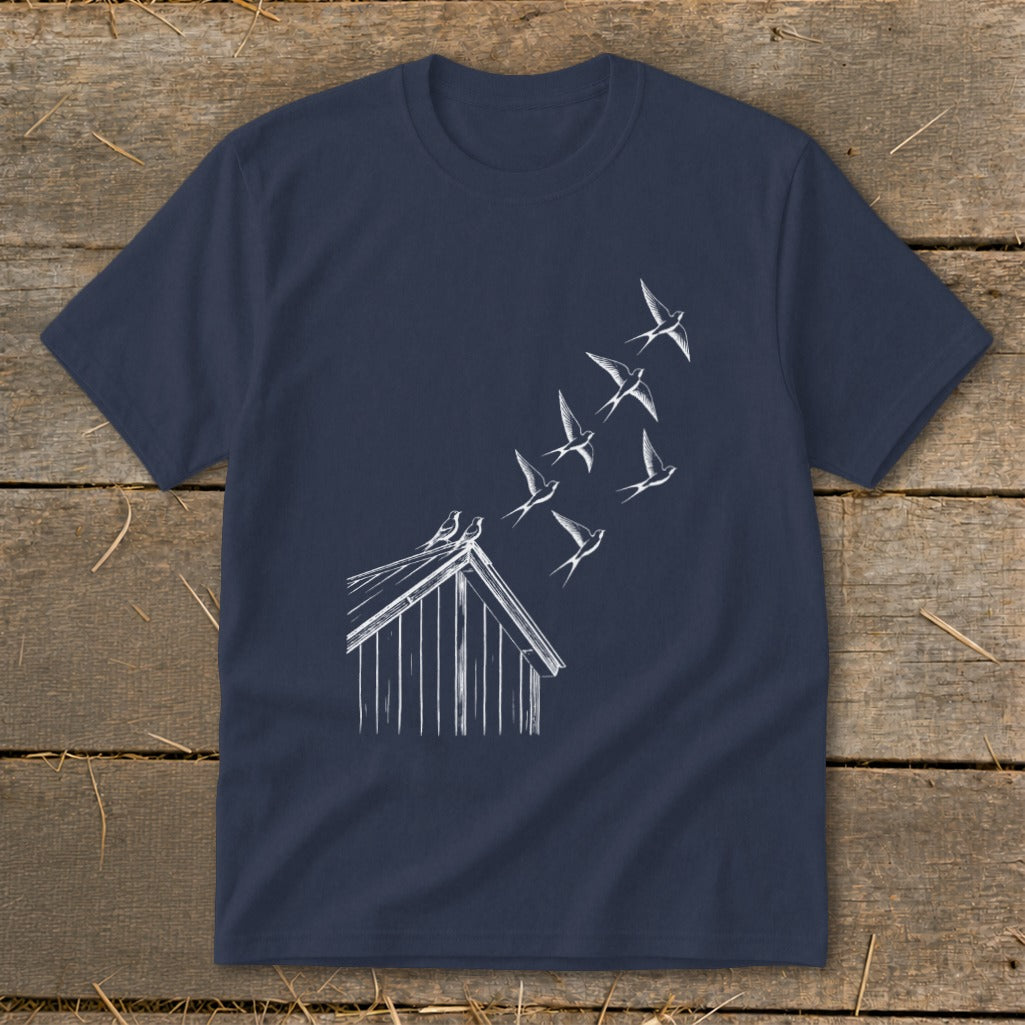 A dark blue short-sleeved t-shirt featuring a white line graphic of birds flying up from a shed roof.
