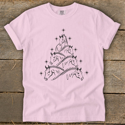 Pink t-shirt with a black graphic of horses arranged in a Christmas tree shape.