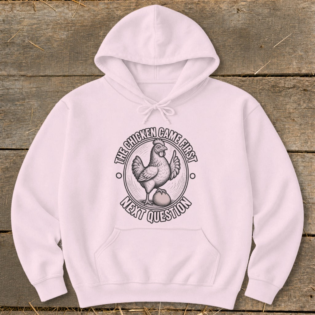 Pink hoodie with a graphic of a chicken on an egg and text "The chicken came first, next question."