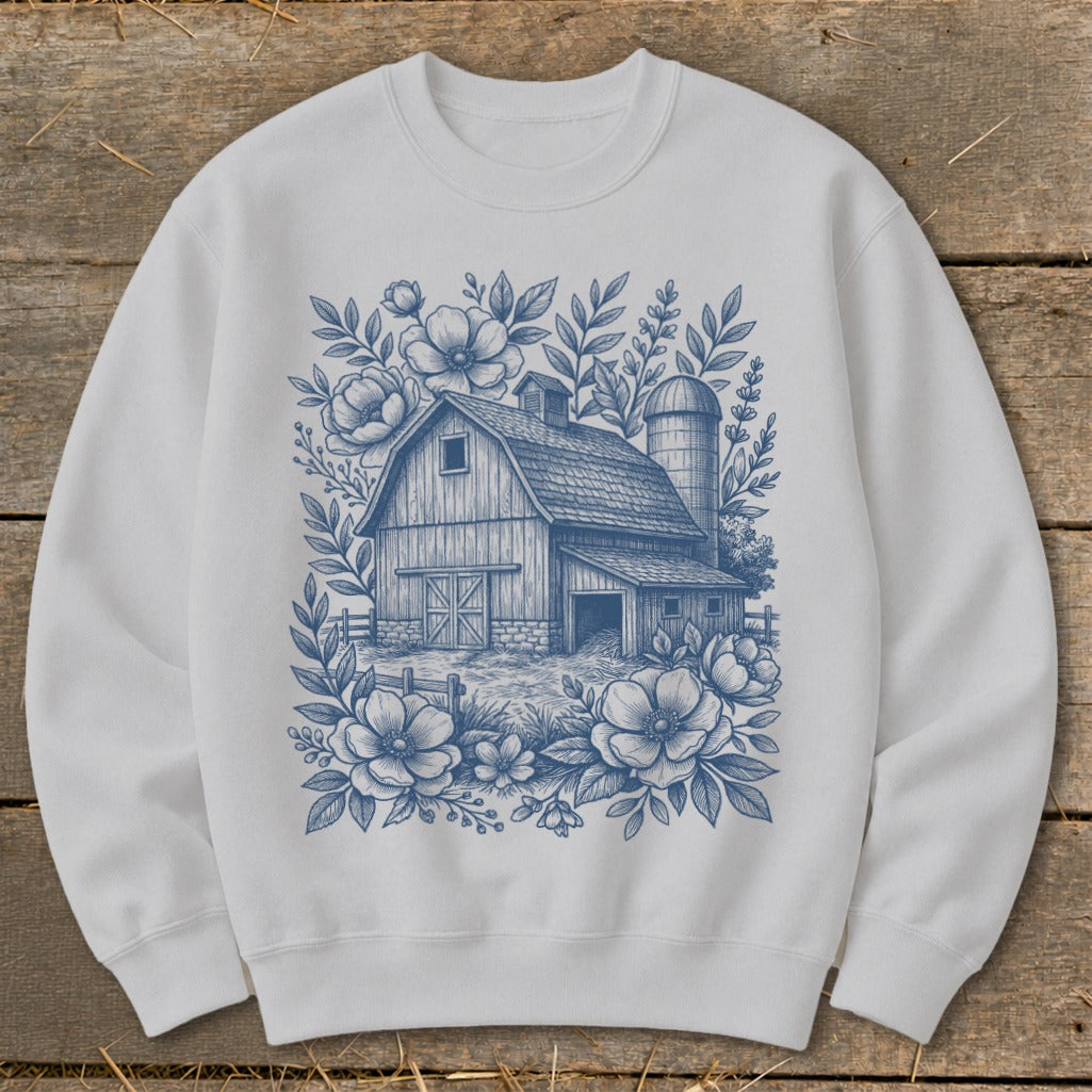 White sweatshirt with a blue floral barn and silo design.