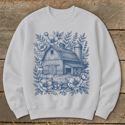 White sweatshirt with a blue floral barn and silo design.