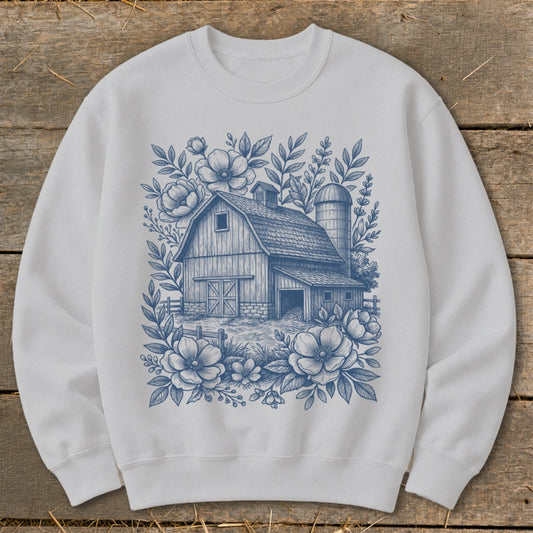 White sweatshirt with a blue floral barn and silo design.
