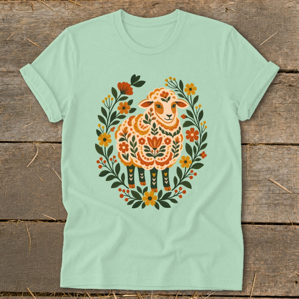 Mint green t-shirt with a stylized sheep in a floral wreath graphic.