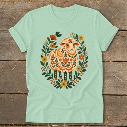Mint green t-shirt with a stylized sheep in a floral wreath graphic.