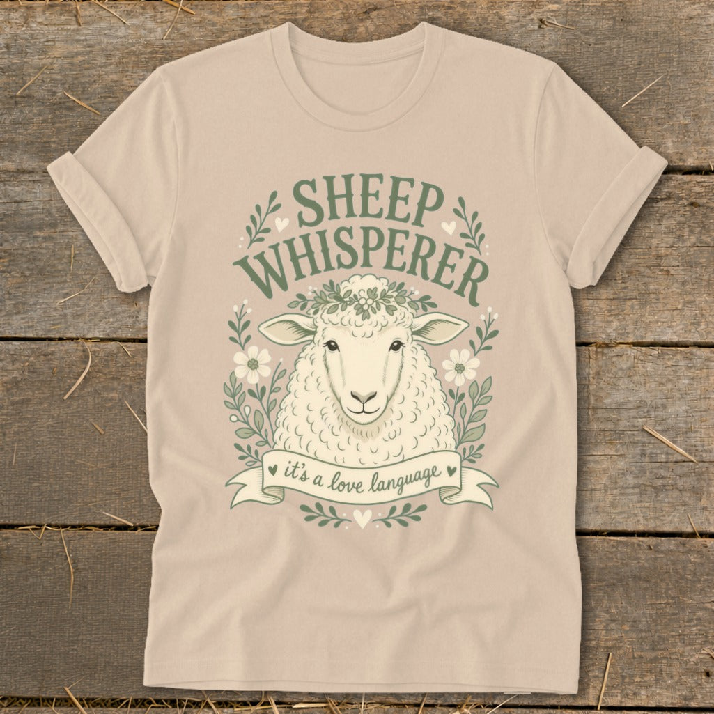 Sheep Whisperer graphic on tan t-shirt with sheep, flowers, and text "it's a love language."