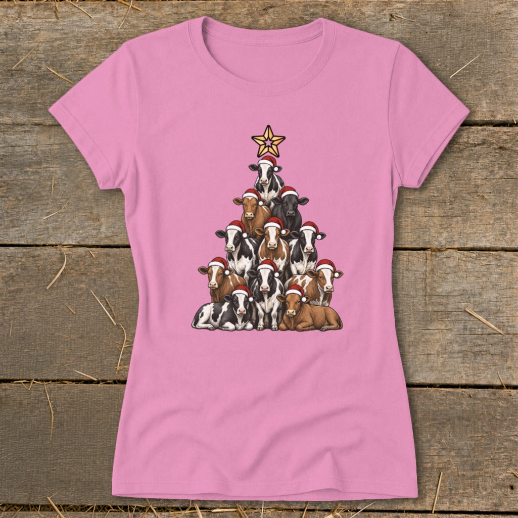 Pink t-shirt with a Christmas tree made of cows wearing Santa hats.