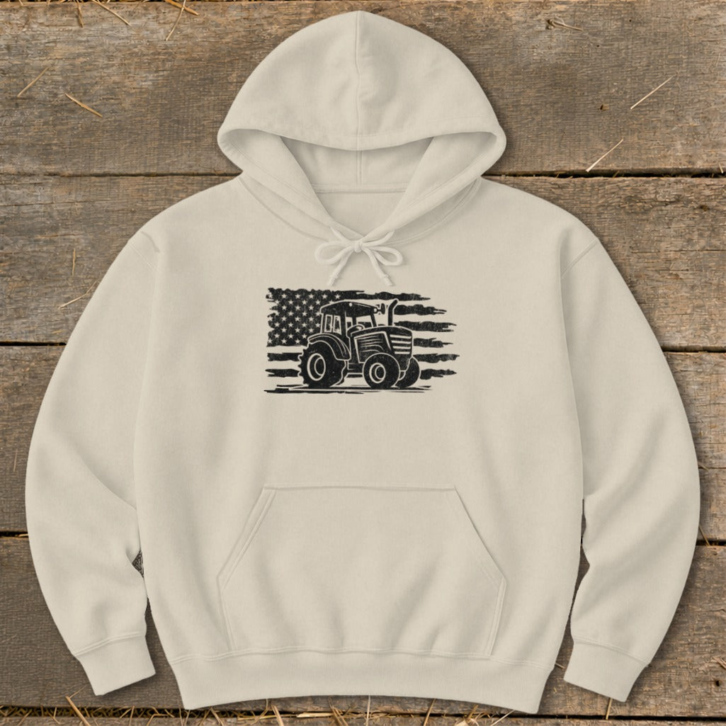 Tan hoodie with a black graphic of a tractor in front of a distressed American flag.