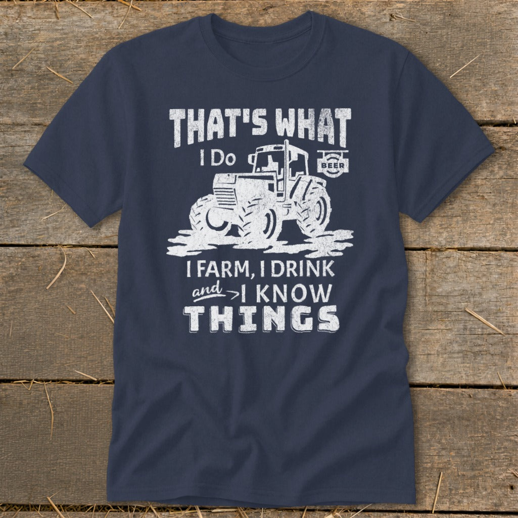 Navy t-shirt with a graphic of a tractor and text: "That's What I Do, I Farm, I Drink, and I Know Things".