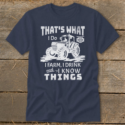 Navy t-shirt with a graphic of a tractor and text: "That's What I Do, I Farm, I Drink, and I Know Things".
