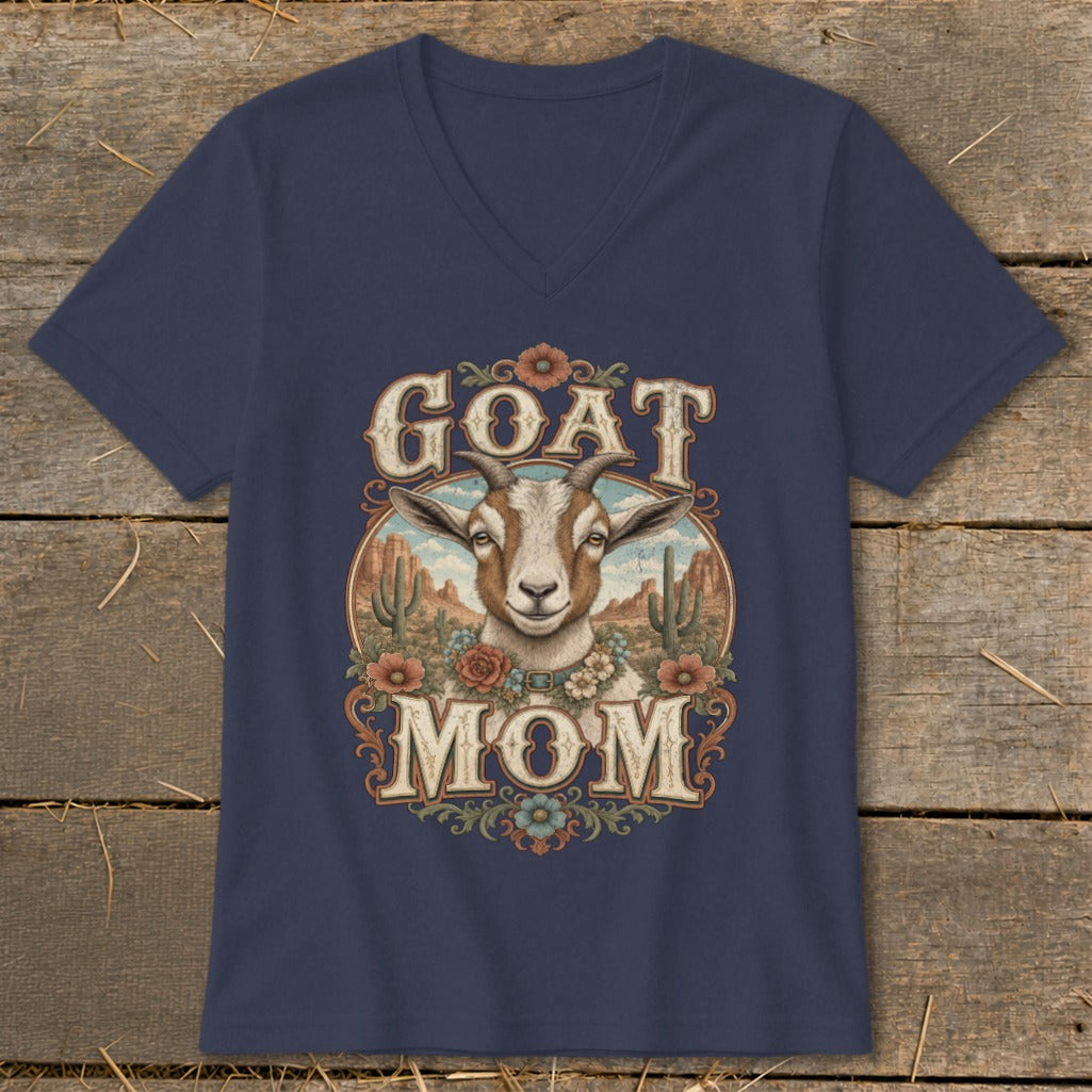 Goat Mom graphic with a goat, desert landscape, and floral accents on a navy shirt.