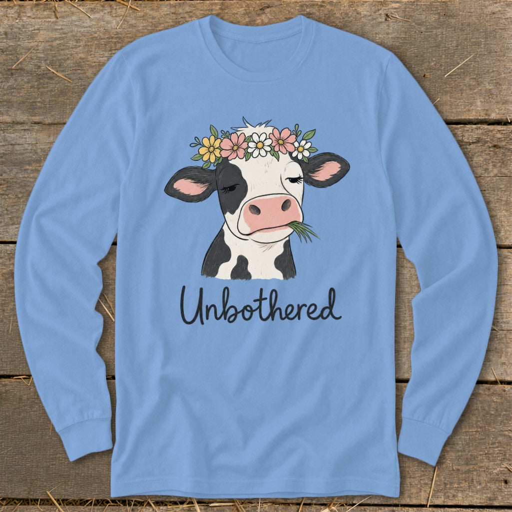 Cow wearing a flower crown chews grass with "Unbothered" text.