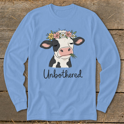 Cow wearing a flower crown chews grass with "Unbothered" text.