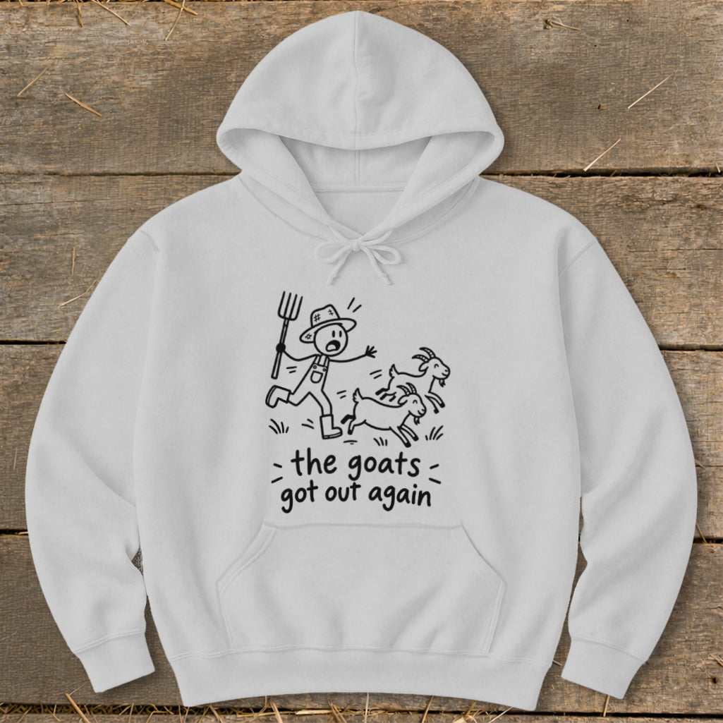 White hoodie with graphic of a farmer chasing goats and text "the goats got out again".