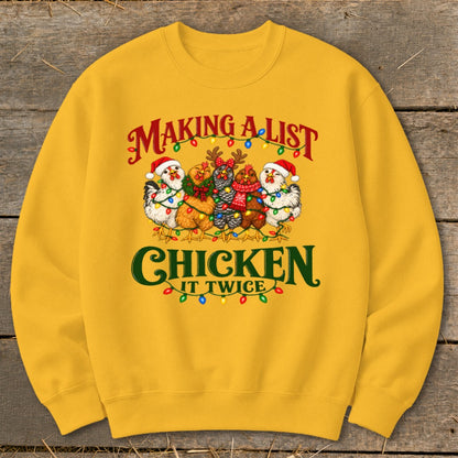 Yellow sweatshirt with chickens wearing Santa hats and Christmas lights, saying "Making a list and chicken it twice".