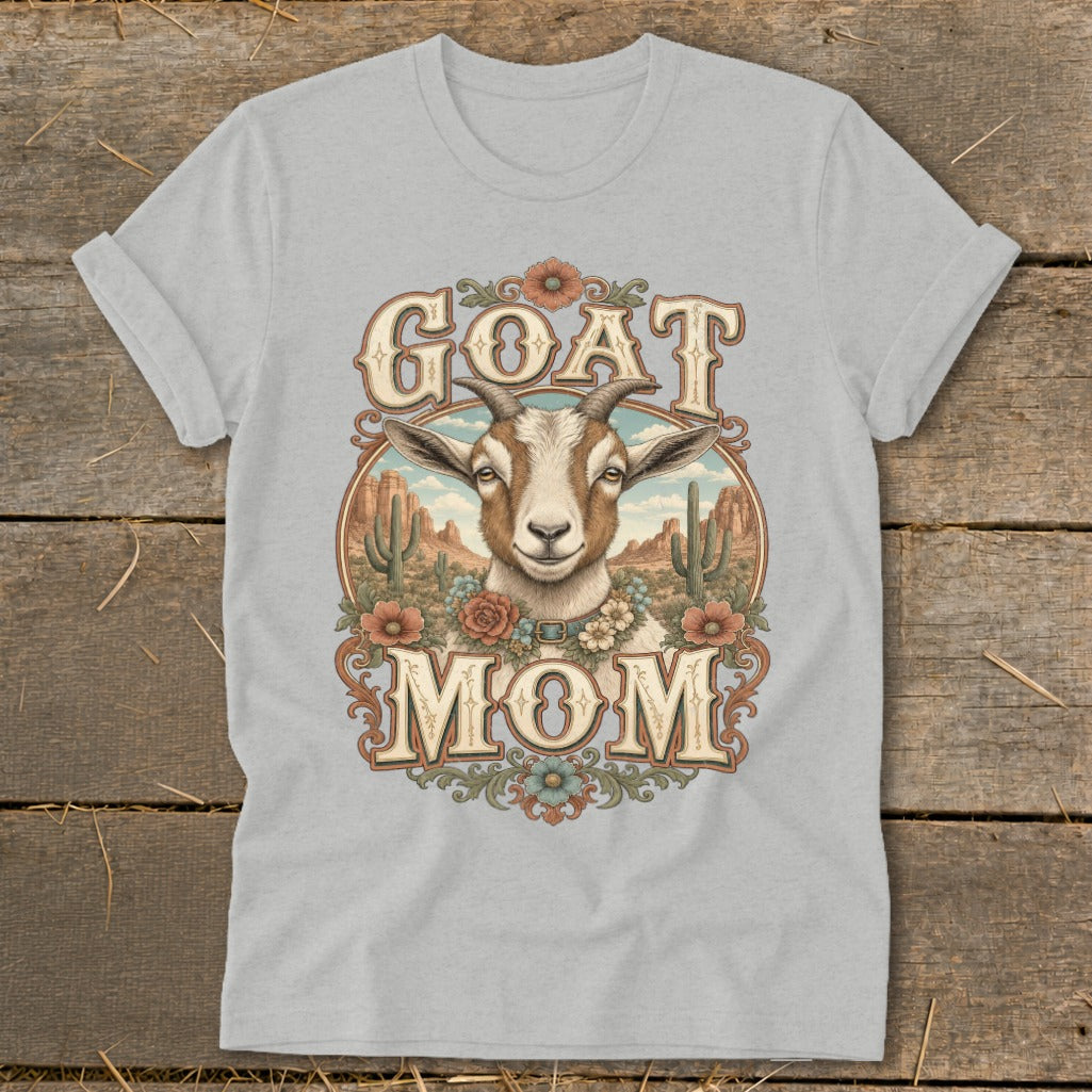 T-shirt graphic featuring a goat head and the words "GOAT MOM" with a desert landscape.