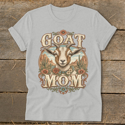 T-shirt graphic featuring a goat head and the words "GOAT MOM" with a desert landscape.