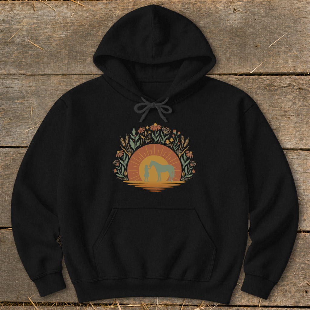 Black hoodie with girl and horse silhouette at sunset surrounded by flowers.