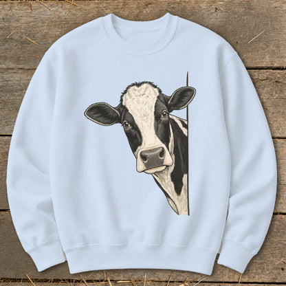 Light blue sweatshirt with a black and white cow peeking from the side.