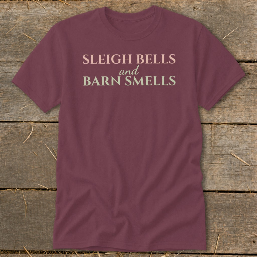 Maroon t-shirt with text "Sleigh Bells and Barn Smells" in pale pink and green.