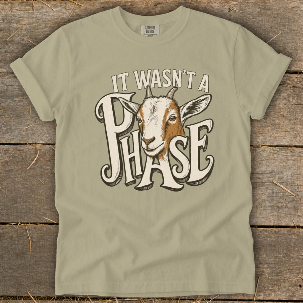 T-shirt with a goat peeking through text that reads "IT WASN'T A PHASE".