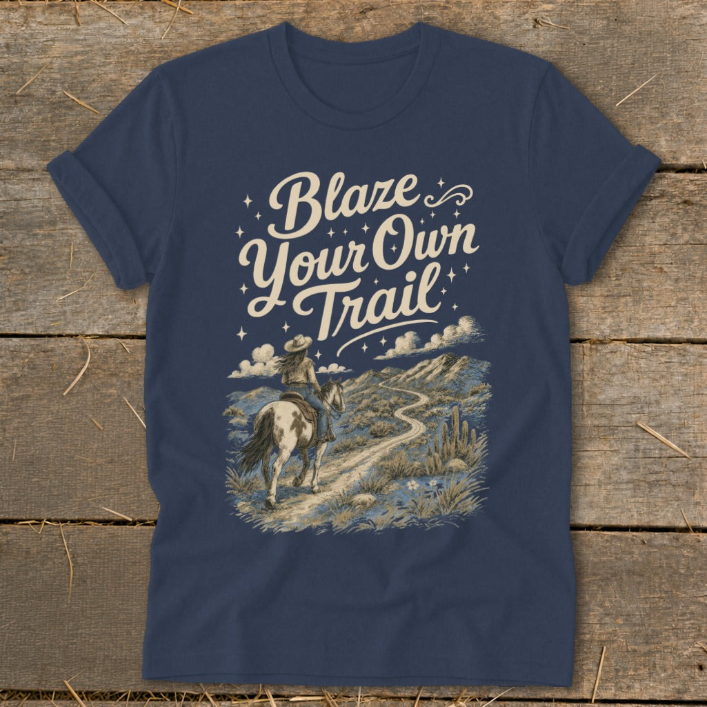 Dark blue t-shirt with "Blaze Your Own Trail" text and a woman riding a horse.