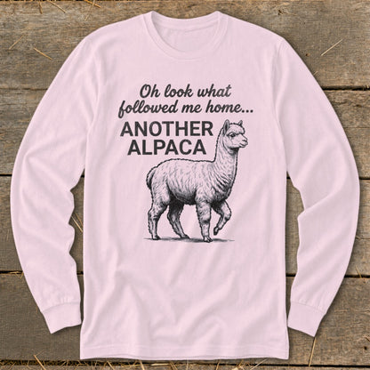 Pink long-sleeve shirt with "Oh look what followed me home... ANOTHER ALPACA" text and alpaca graphic.