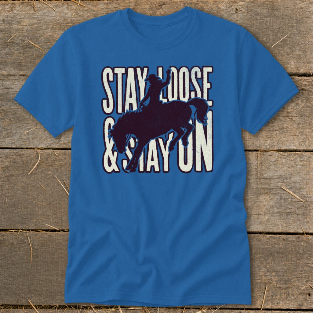 Blue t-shirt with distressed graphic of bucking bronco and text "STAY LOOSE & STAY ON".