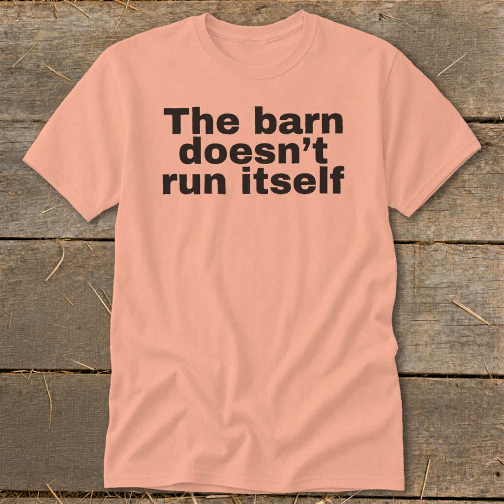 Peach t-shirt with black text "The barn doesn't run itself".