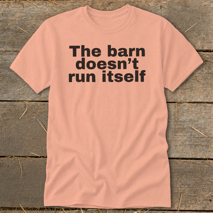 Peach t-shirt with black text "The barn doesn't run itself".