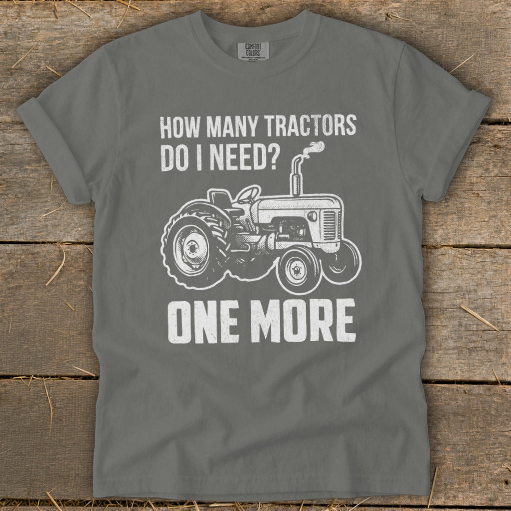 Gray t-shirt with white text and tractor graphic that reads "How Many Tractors Do I Need? One More."