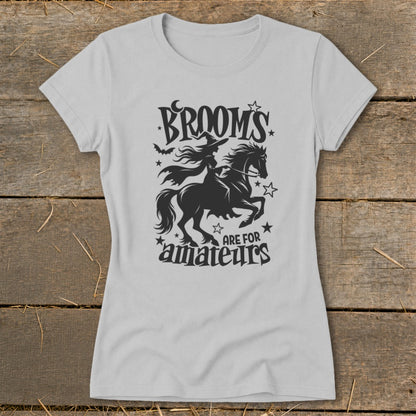 Gray t-shirt with black graphic of a witch riding a horse, bats, moon, and stars with text.