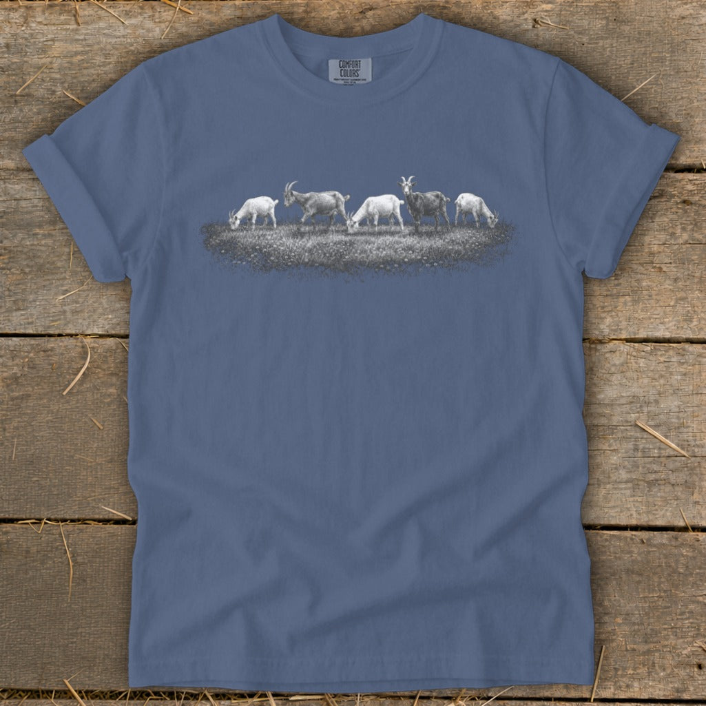Slate blue t-shirt with a line of goats grazing in a field graphic.