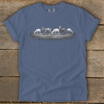 Slate blue t-shirt with a line of goats grazing in a field graphic.