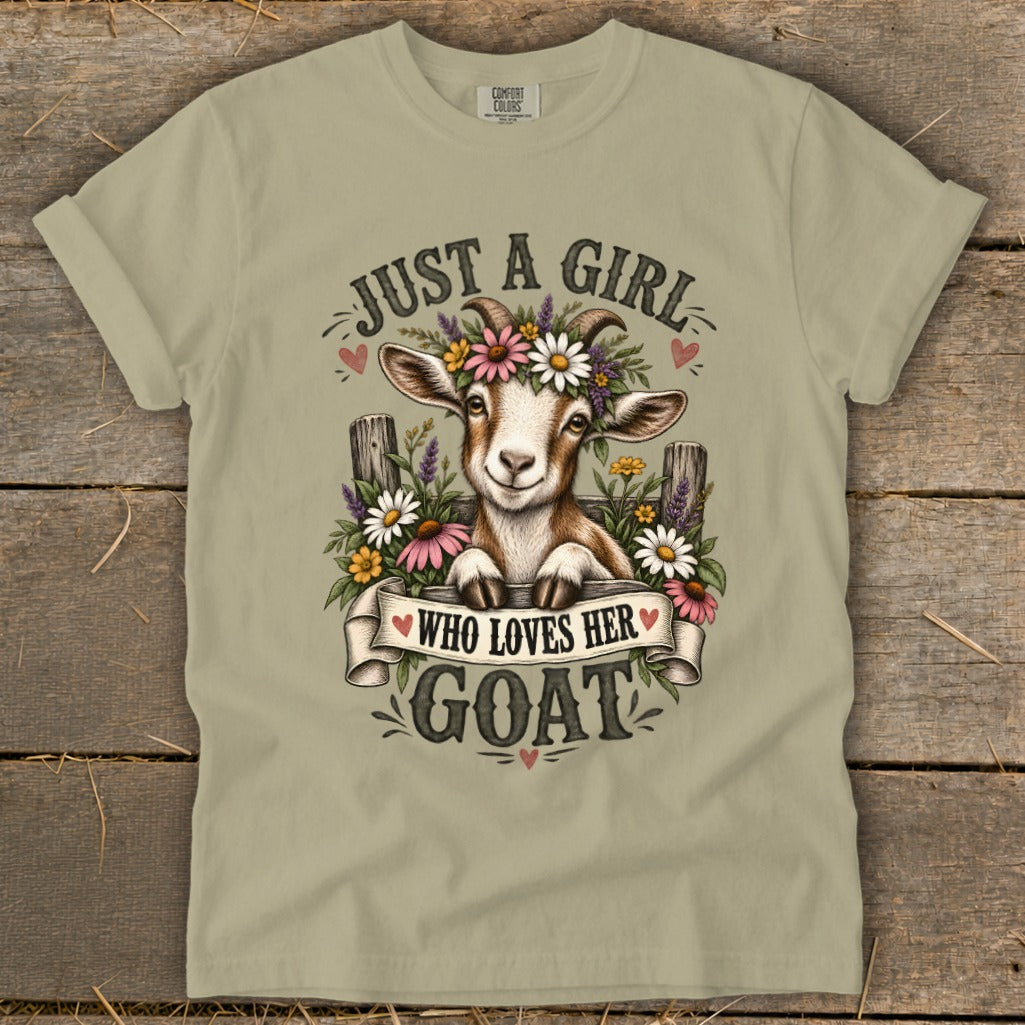 Light tan t-shirt with "Just a girl who loves her goat" graphic featuring a goat with flowers.