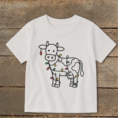 White t-shirt with a line drawing of a cow wrapped in Christmas lights.