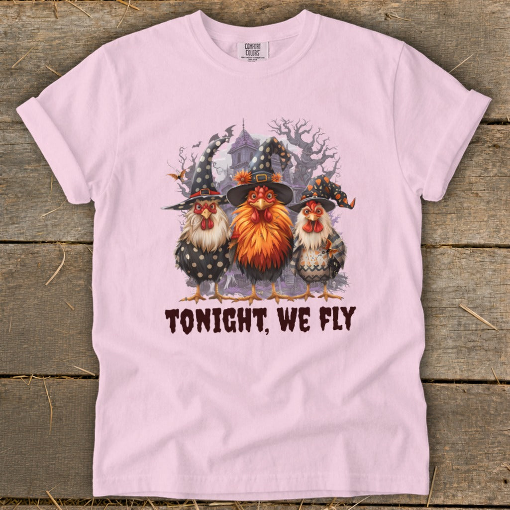 Three roosters in witch hats stand before a haunted house with the text "TONIGHT, WE FLY".