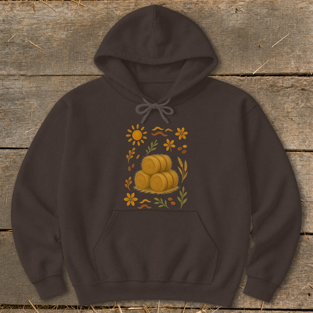 Brown hoodie with a fall-themed graphic of hay bales, sun, and flowers.