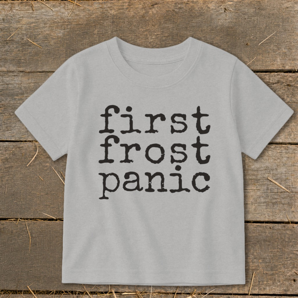 Light grey t-shirt with black text "first frost panic" in typewriter font.