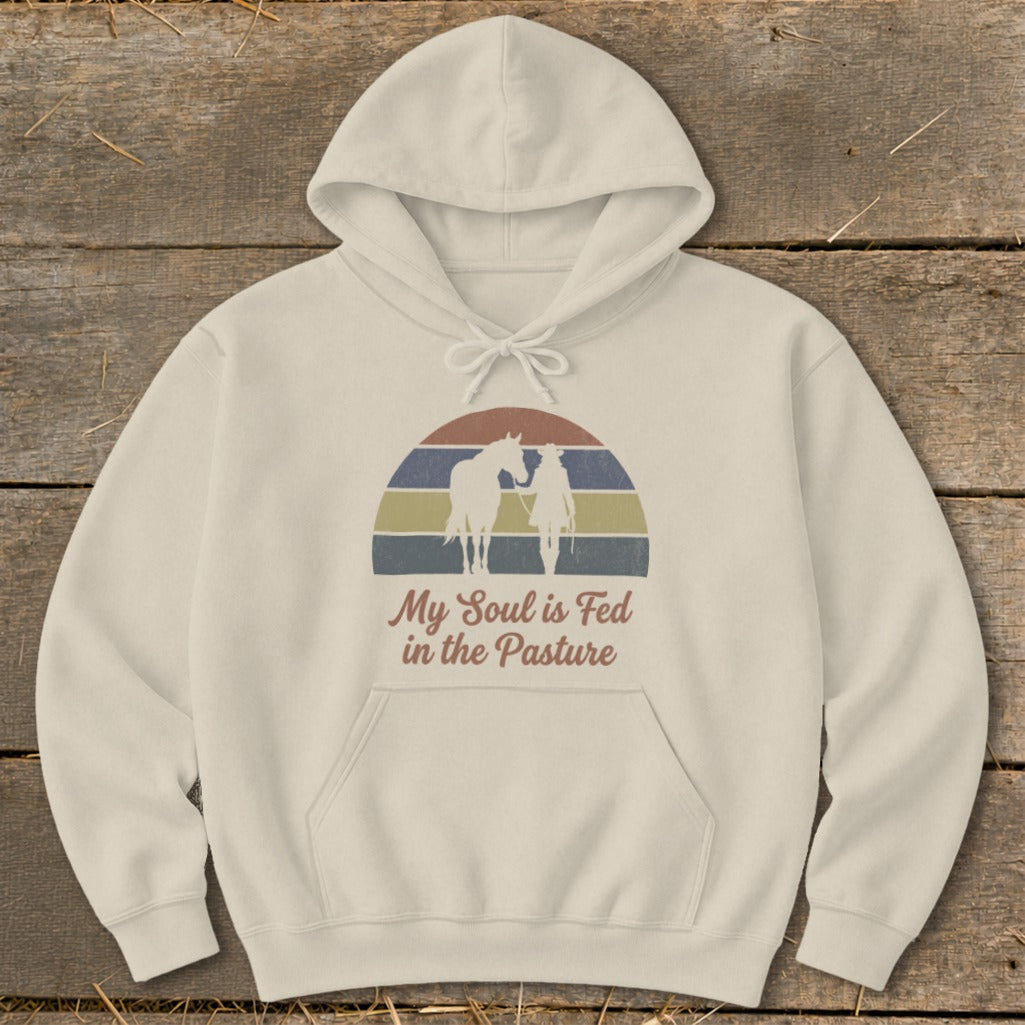 Cream hoodie with vintage horse and rider silhouette and text "My Soul is Fed in the Pasture."