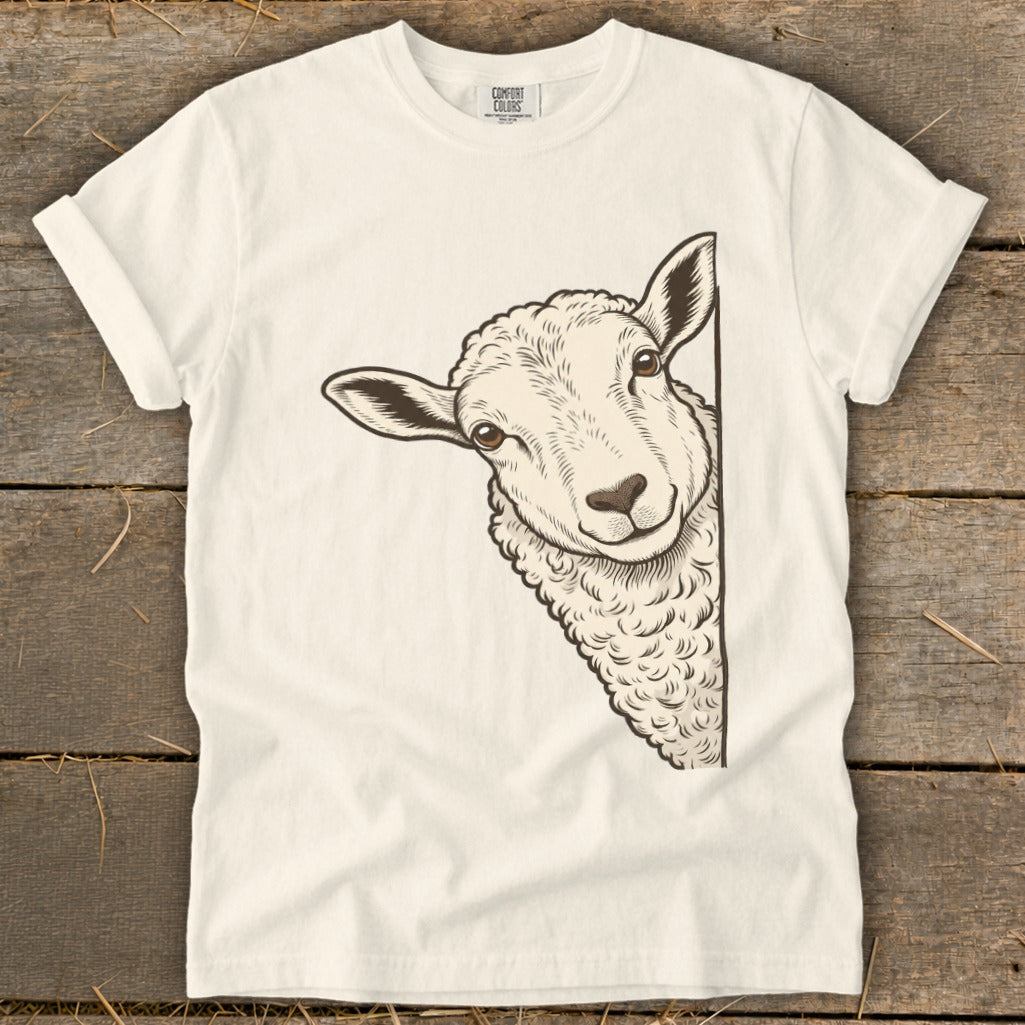 Illustration of a sheep peeking from the side of a cream-colored t-shirt.