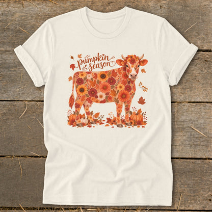 Cow covered in autumn flowers and leaves with "Pumpkin Season" text.