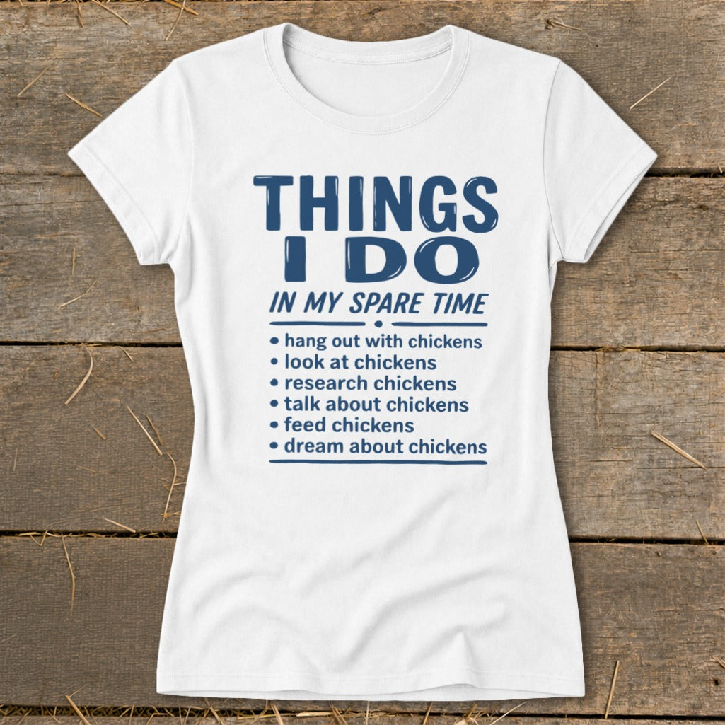 White t-shirt with blue text listing chicken-related activities in spare time.