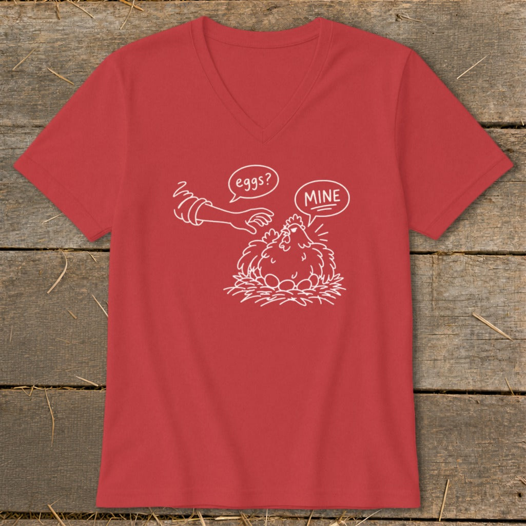 Red v-neck t-shirt with white line drawing of a chicken on eggs, saying "MINE" to a hand asking "eggs?".