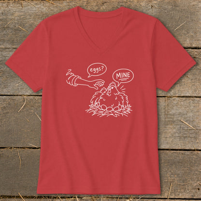Red v-neck t-shirt with white line drawing of a chicken on eggs, saying "MINE" to a hand asking "eggs?".