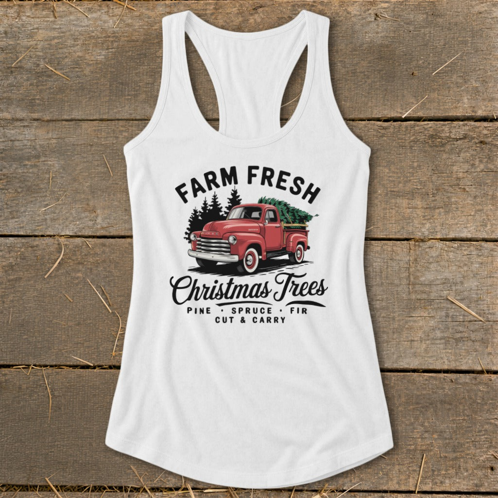 White tank top with "Farm Fresh Christmas Trees" graphic featuring a red truck with trees.